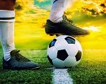 feet of football player tread on soccer ball