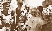 Sister_of_the_St._Louis_Hospital_in_Jerusalem_holding_up_a_denture_recovered_after_having_fallen_out_of_the_window_into_no-man's-land,_22_May_1956